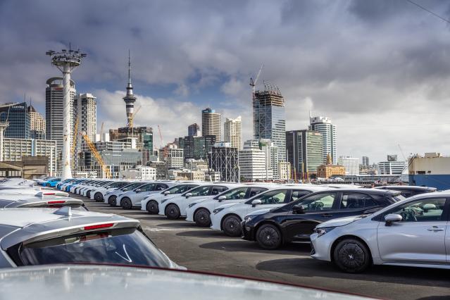 Cars offloaded with Auckland city behind at Port of Auckland